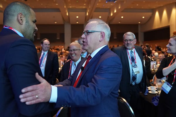 Tony Sanneh spoke with Gov. Tim Walz during a Minneapolis Chamber of Commerce event last year.
