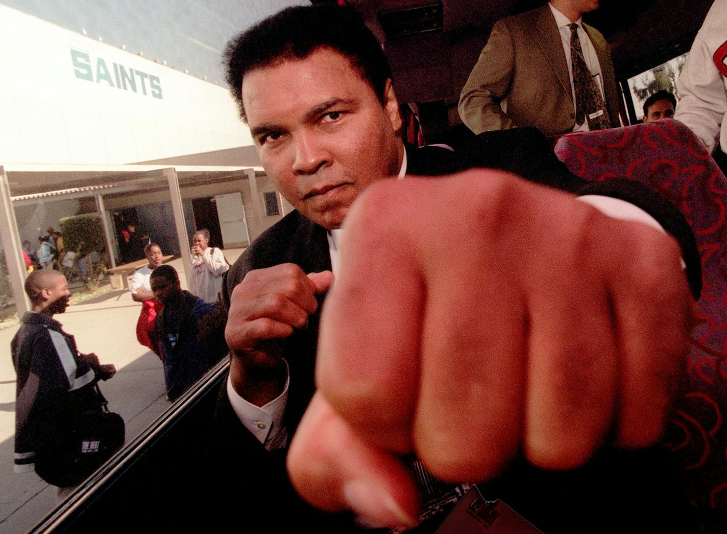 Muhammad Ali throws playful punch toward a photographer while visiting Locke High School in Los Angeles on December 4, 1996. Muhammad Ali died on Friday, June 3, 2016, at 74. (Ken Lubas/Los Angeles Times/TNS)