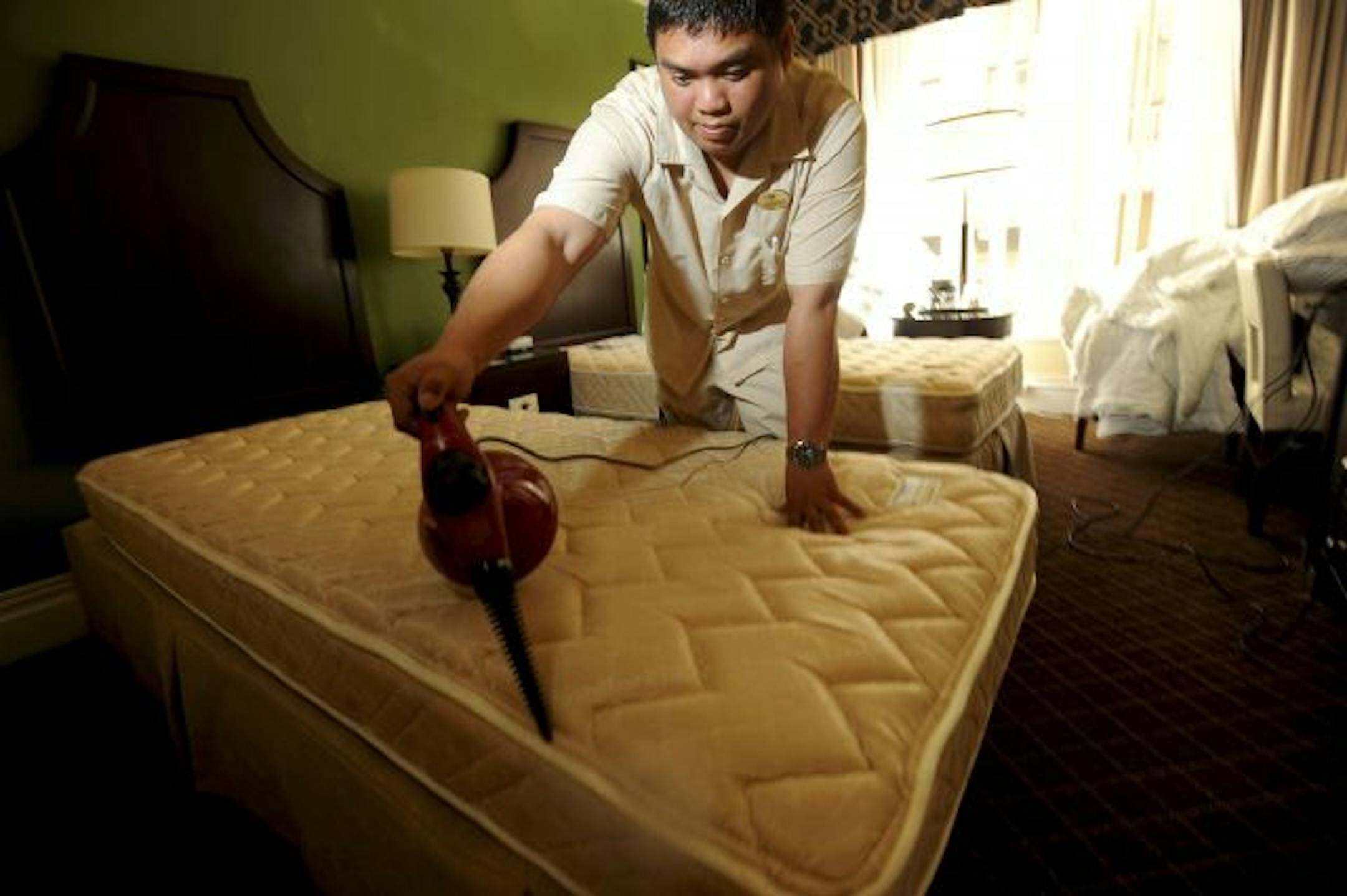 Jonell Bolivar steams a mattress at the Chancellor Hotel as a preventive measure against bedbugs in San Francisco, on Aug. 31, 2010. Businesses like pest control companies and cleaning services that were hit by clients cutting back during the recession have found a new boon in bedbug elimination.