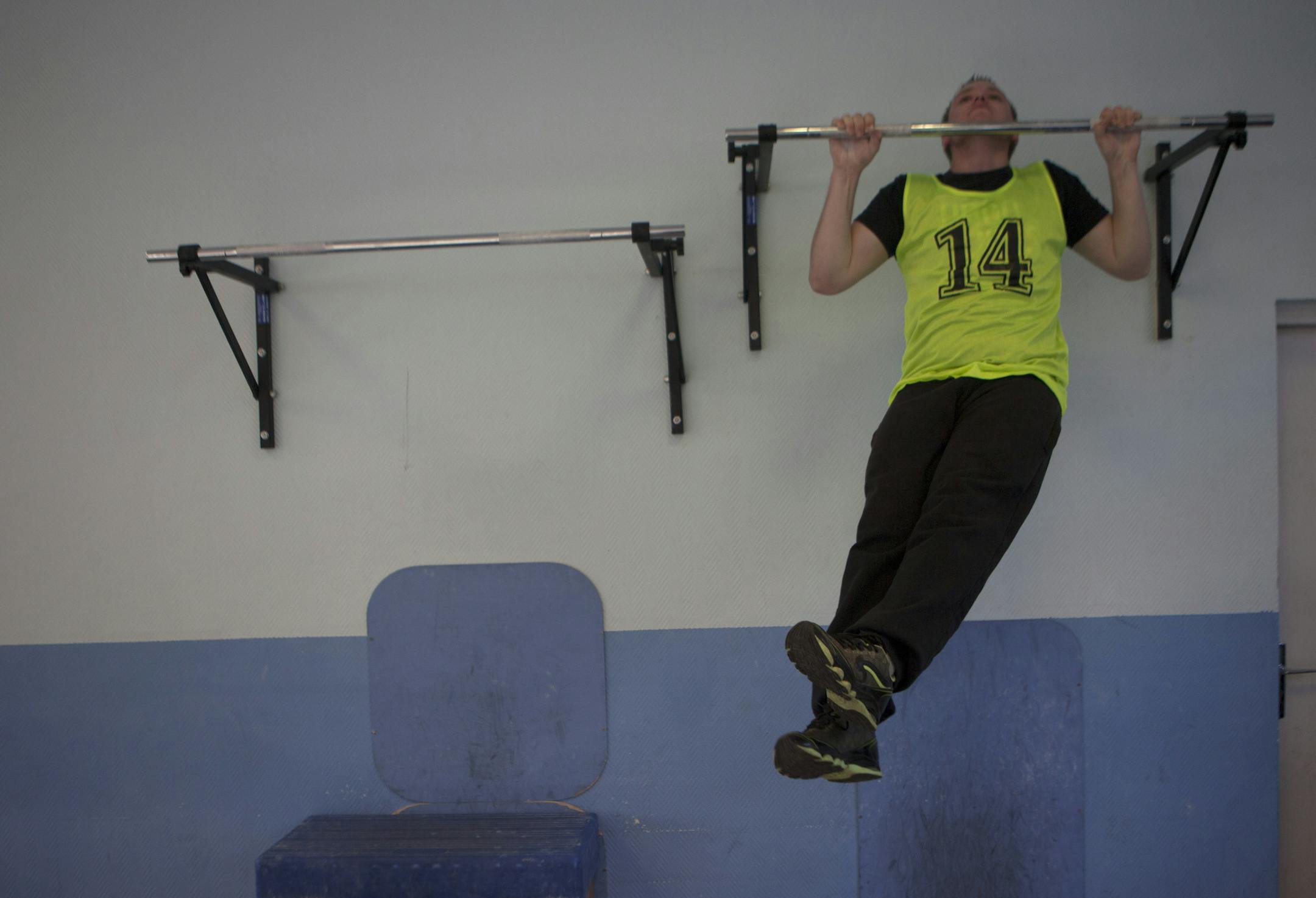 A recruit for the French army does pull-ups at the Fort Neuf de Vincennes in eastern Paris, Nov. 23, 2015. Thousands of people have been rushing to sign up with the military since the killing spree by Islamic State militants that left 130 dead in Paris more than a week ago. (Pierre Terdjman/The New York Times)