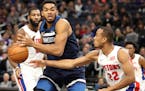 Minnesota Timberwolves center Karl-Anthony Towns (32) passes the ball while Detroit Pistons guard Avery Bradley (22) defends during the first half. ] 