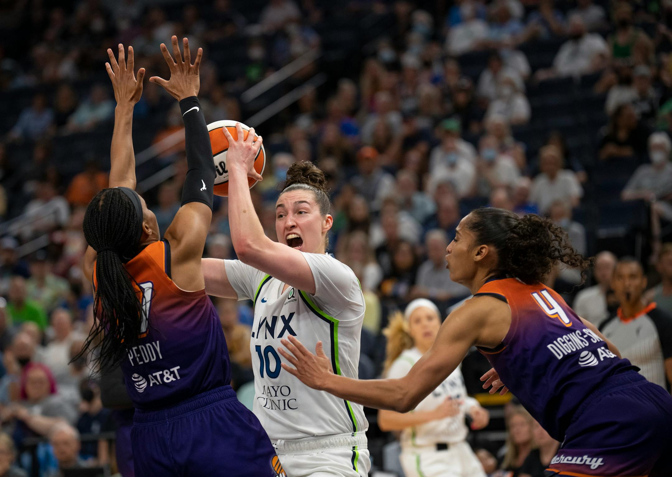 Minnesota Lynx forward Jessica Shepard (10) looked for a first quarter shot opportunity while defended by Phoenix Mercury guards Shey Peddy (11) and Skylar Diggins-Smith (4).