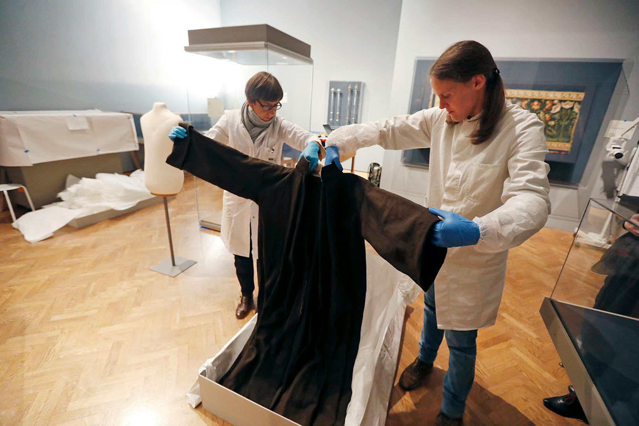 Eva D¸llo left and Andrea Kn¸pfer, German textile conservators unpacked a 16th century monks robe, the style that Luther wore, at The Minneapolis Institute of Art Thursday October 20, 2016 in Minneapolis, MN. ] First exhibition marking 500th anniversary of Martin Luther's "Ninety-Five Theses" opens at the Minneapolis Institute of Art October 30. Jerry Holt / jerry. Holt@Startribune.com