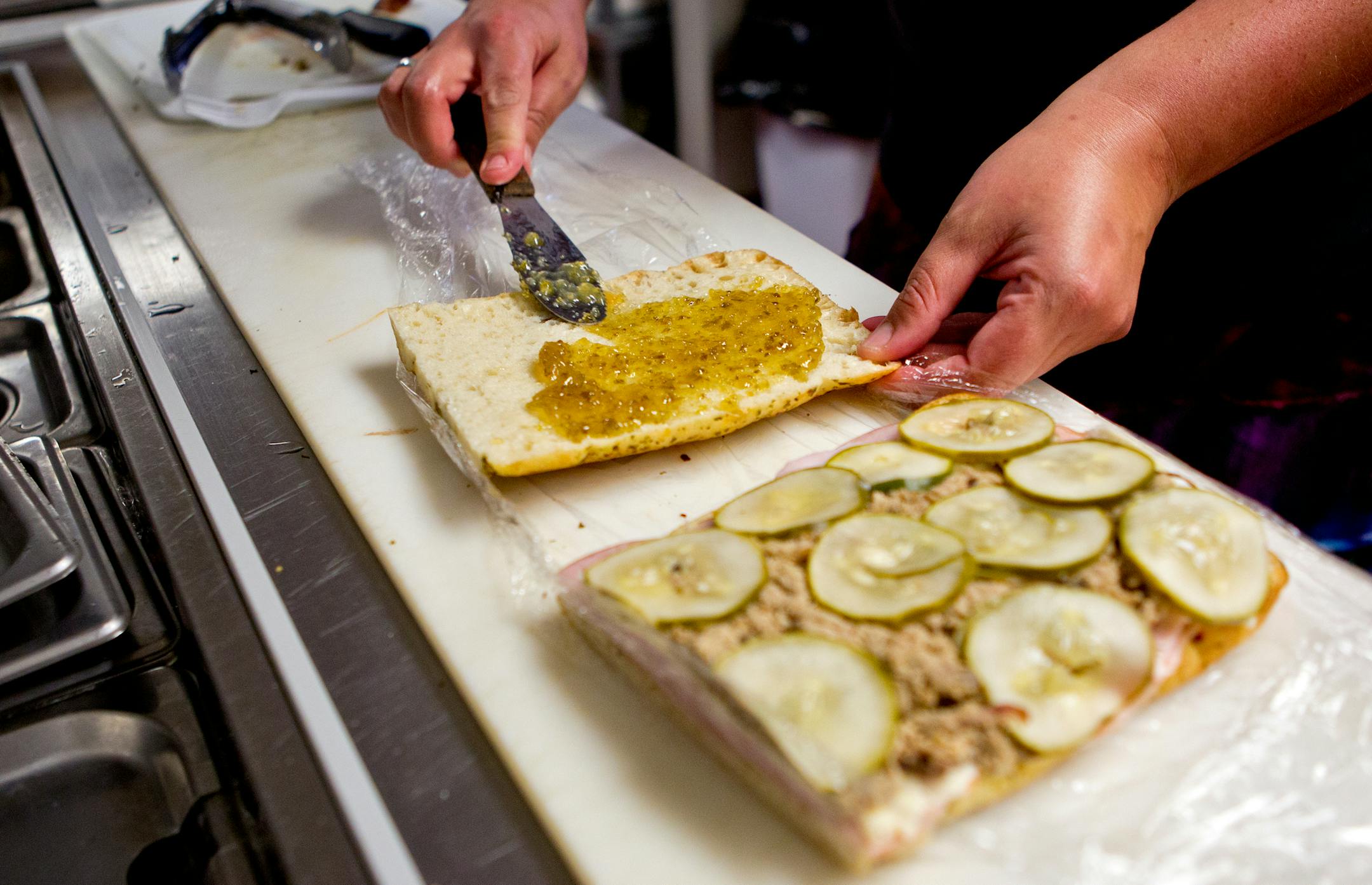Koli Fyten-Swap spreads her signature jalapeno garlic jam on a Cuban sandwich at Jellybean and Julia's deli in Anoka, Minn., on Wednesday, June 4, 2013. Her and her husband, Cory Swap, started a food truck business a year ago and opened the indoor shop on Friday, May 31, 2013. They make everything from scratch, including the homemade mustards, jams and sauces. ] (ANNA REED/STAR TRIBUNE) anna.reed@startribune.com