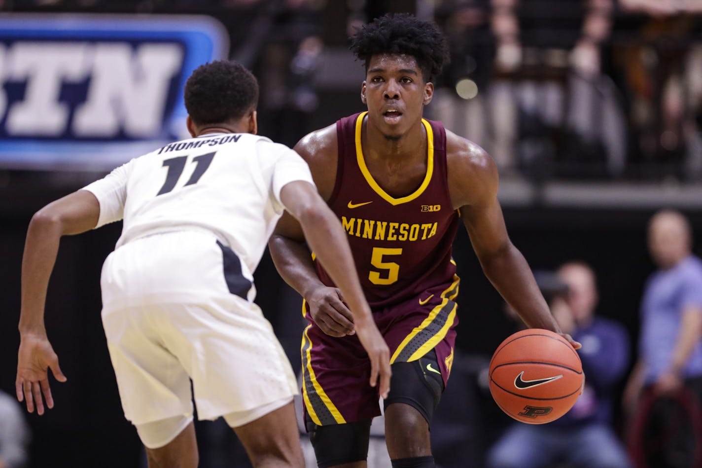 Purdue guard Isaiah Thompson (11) defends against Minnesota guard Marcus Carr (5) during the first half of an NCAA college basketball game in West Lafayette, Ind., Thursday, Jan. 2, 2020. (AP Photo/Michael Conroy)