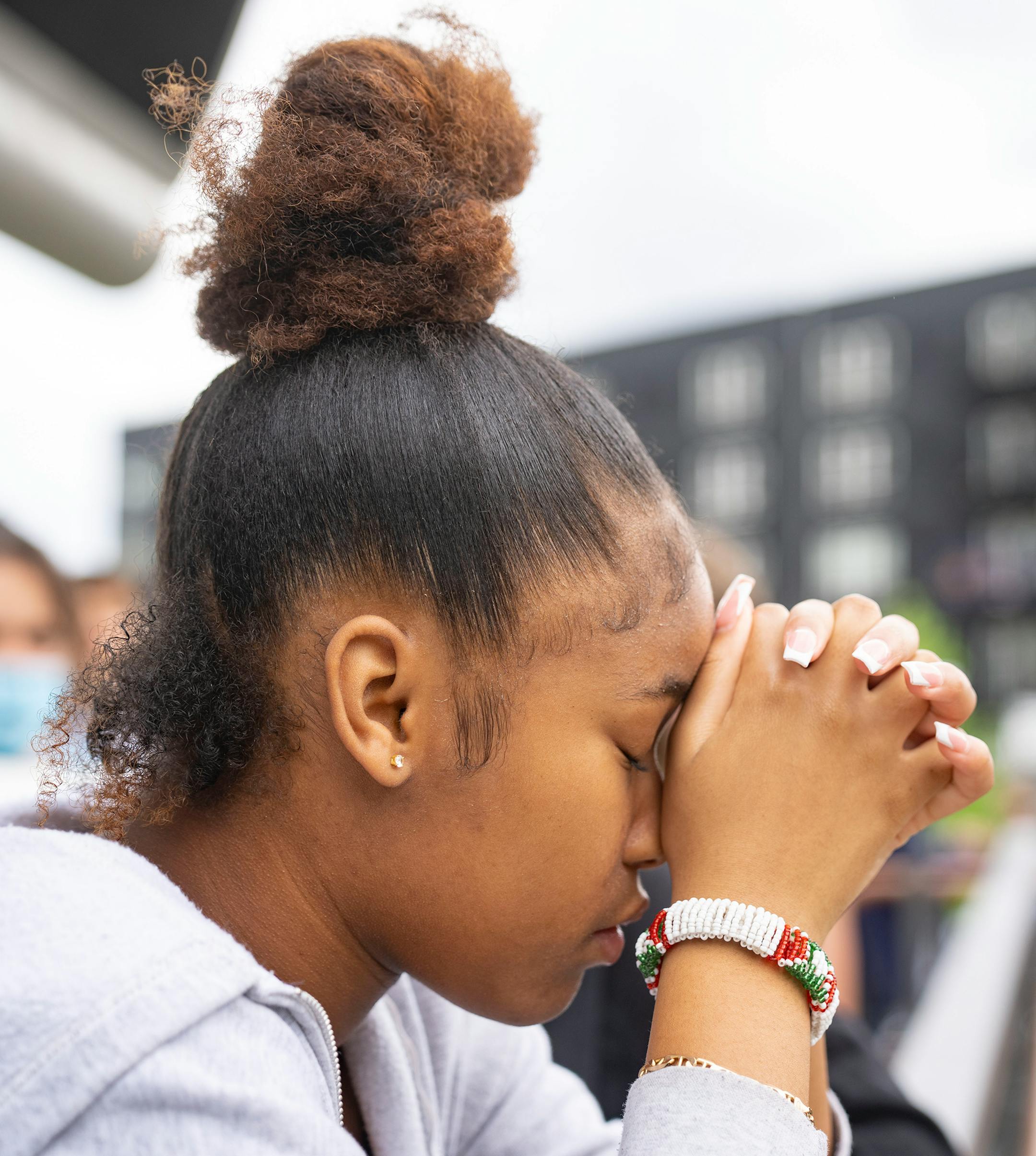 Jada Williams bows her head in prayer during a student walkout and march to protest gun violence.