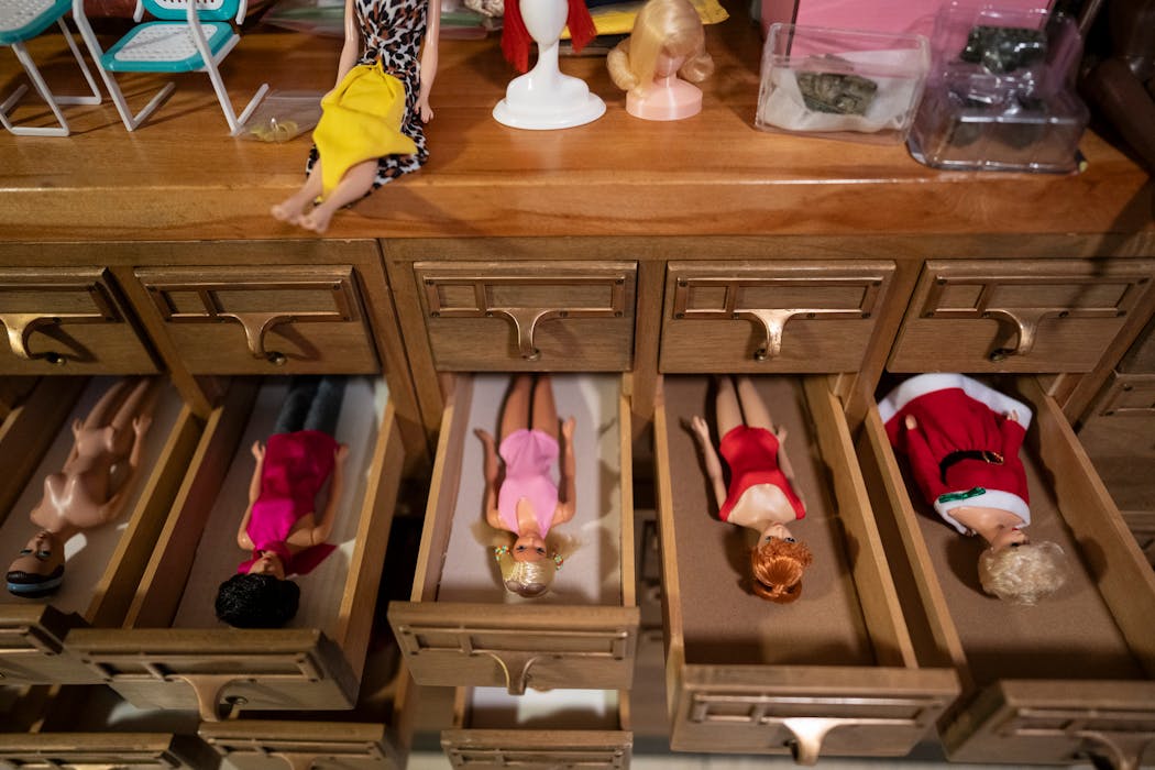 Nicole Houff creates painstakingly detailed Barbie-sized scenes and photographs them, creating fun and retro-inspired photos that she then sells at art fairs. She stores her dolls in an old card cabinet in her studio.