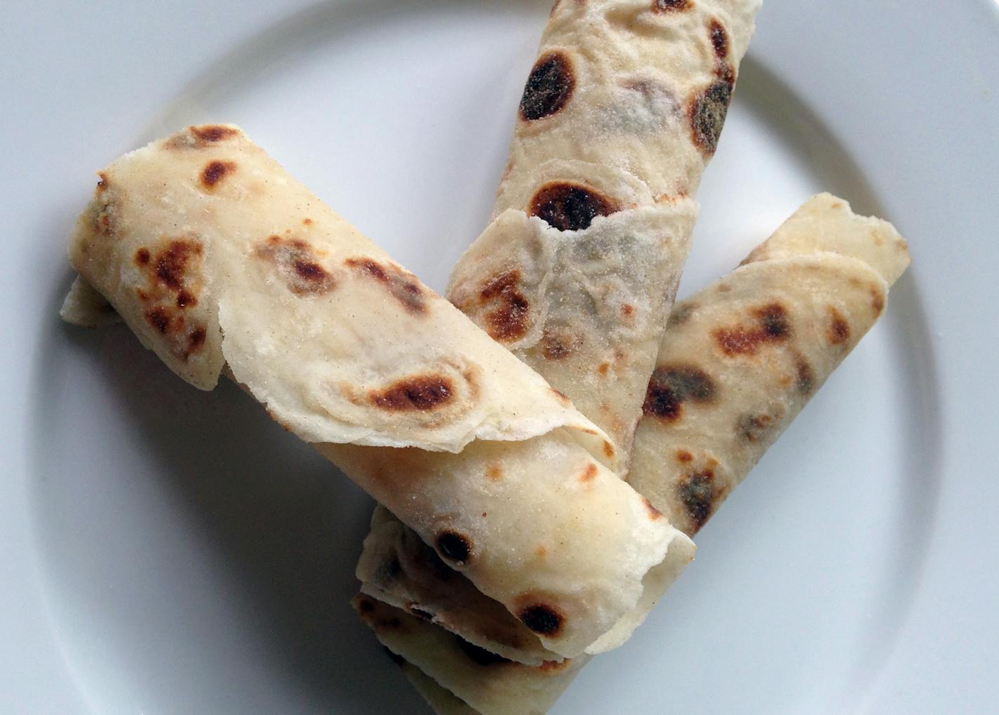 Fresh lefse, wrapped with butter and sugar, made by women at Central Lutheran Church. (Lee Svitak Dean/Star Tribune)