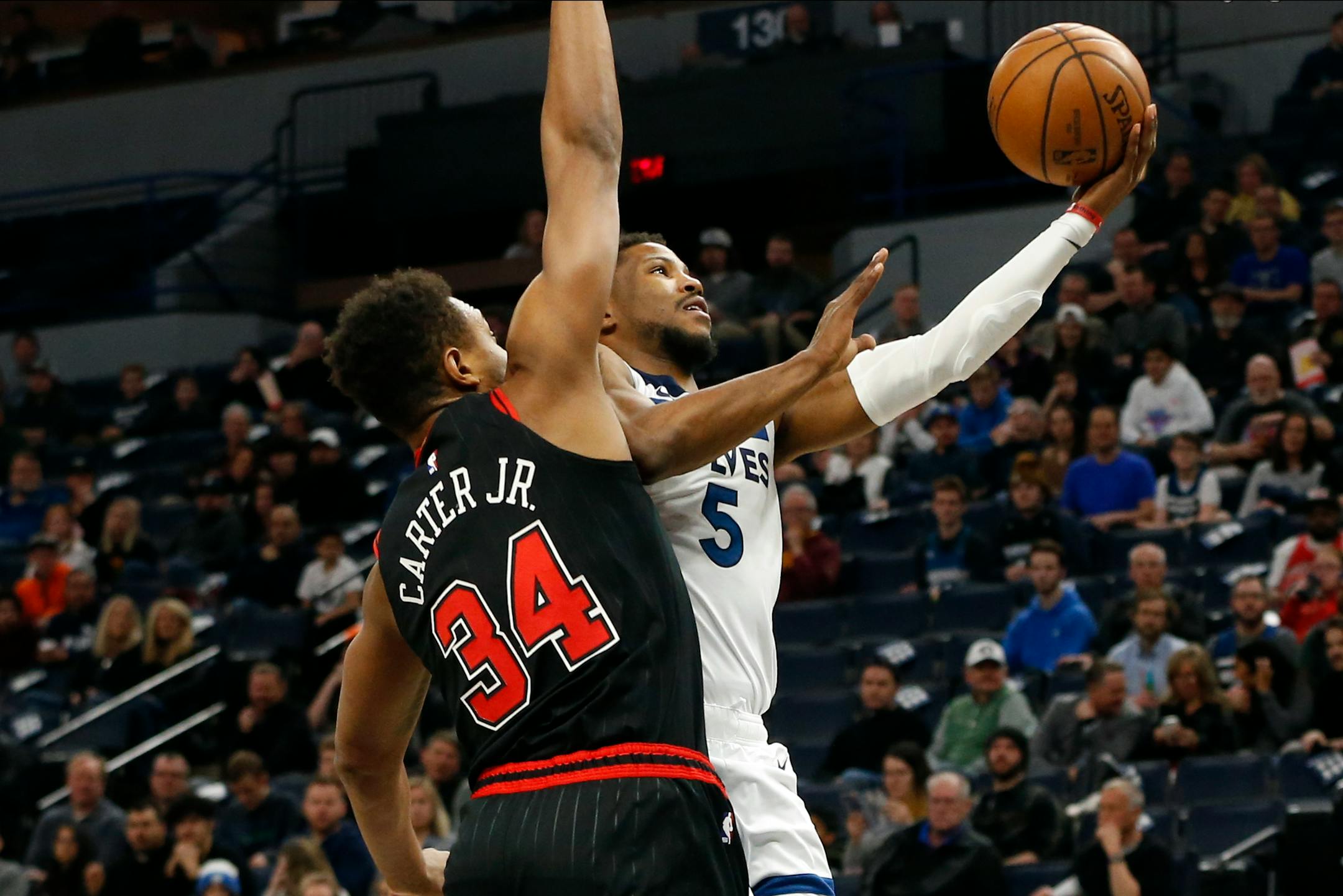 The Timberwolves' Malik Beasley lays up a shot as Chicago's Wendell Carter Jr. defends in the first half