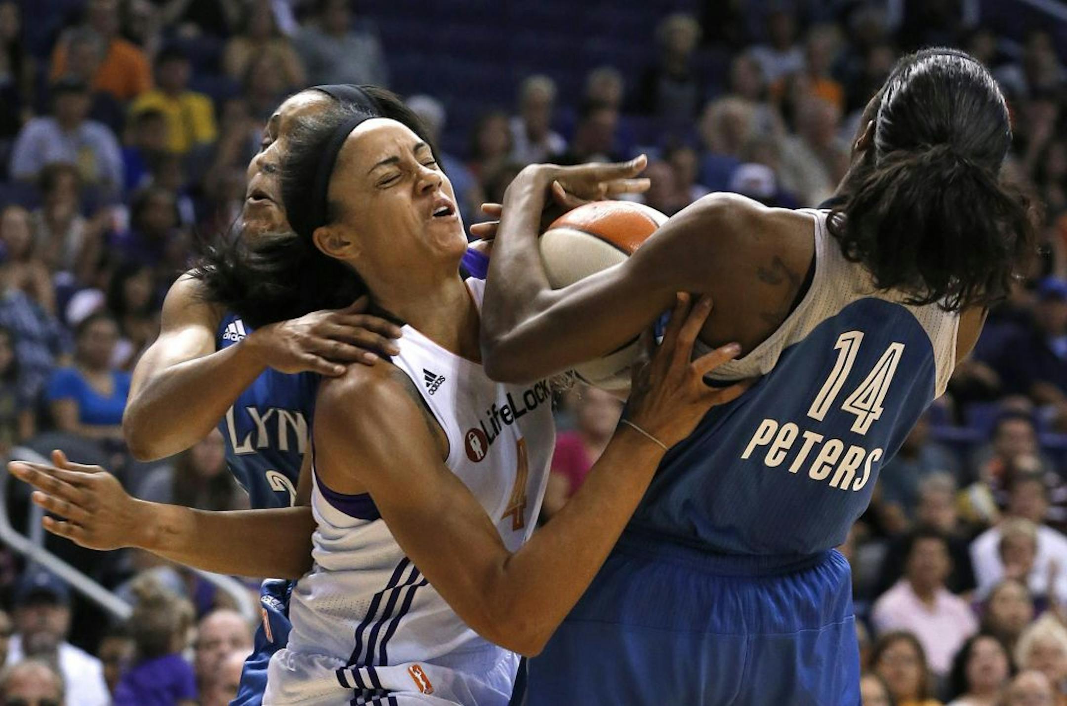 Phoenix Mercury's Candice Dupree (4) scrambles with Minnesota Lynx's Devereaux Peters (14) and Maya Moore for a loose ball during the first half of a WNBA basketball game Sunday, July 21, 2013, in Phoenix.