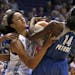 Phoenix Mercury's Candice Dupree (4) scrambles with Minnesota Lynx's Devereaux Peters (14) and Maya Moore for a loose ball during the first half of a 