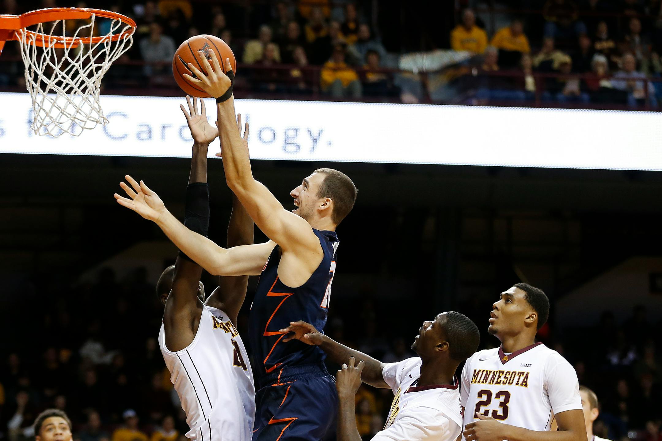 Illinois center Maverick Morgan took the ball to the basket against Gophers center Bakary Konate (21) in the first half of the Illini's 76-71 overtime victory Saturday.