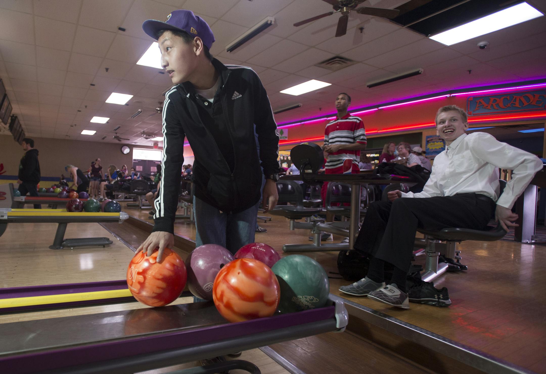Yeng Her, a 10th grader at Tartan High School, grabbed his ball from the ball return before practicing his roll on Tuesday afternoon. ] (Aaron Lavinsky | StarTribune) aaron.lavinsky@startribune.com We photograph Tartan adapted bowlers Justin Breister and Yeng Her, two tenth graders who returned to the team after winning a state title in 2014. They practiced on Tuesday, April 28, 2015 at Sun Ray Lanes in St. Paul.