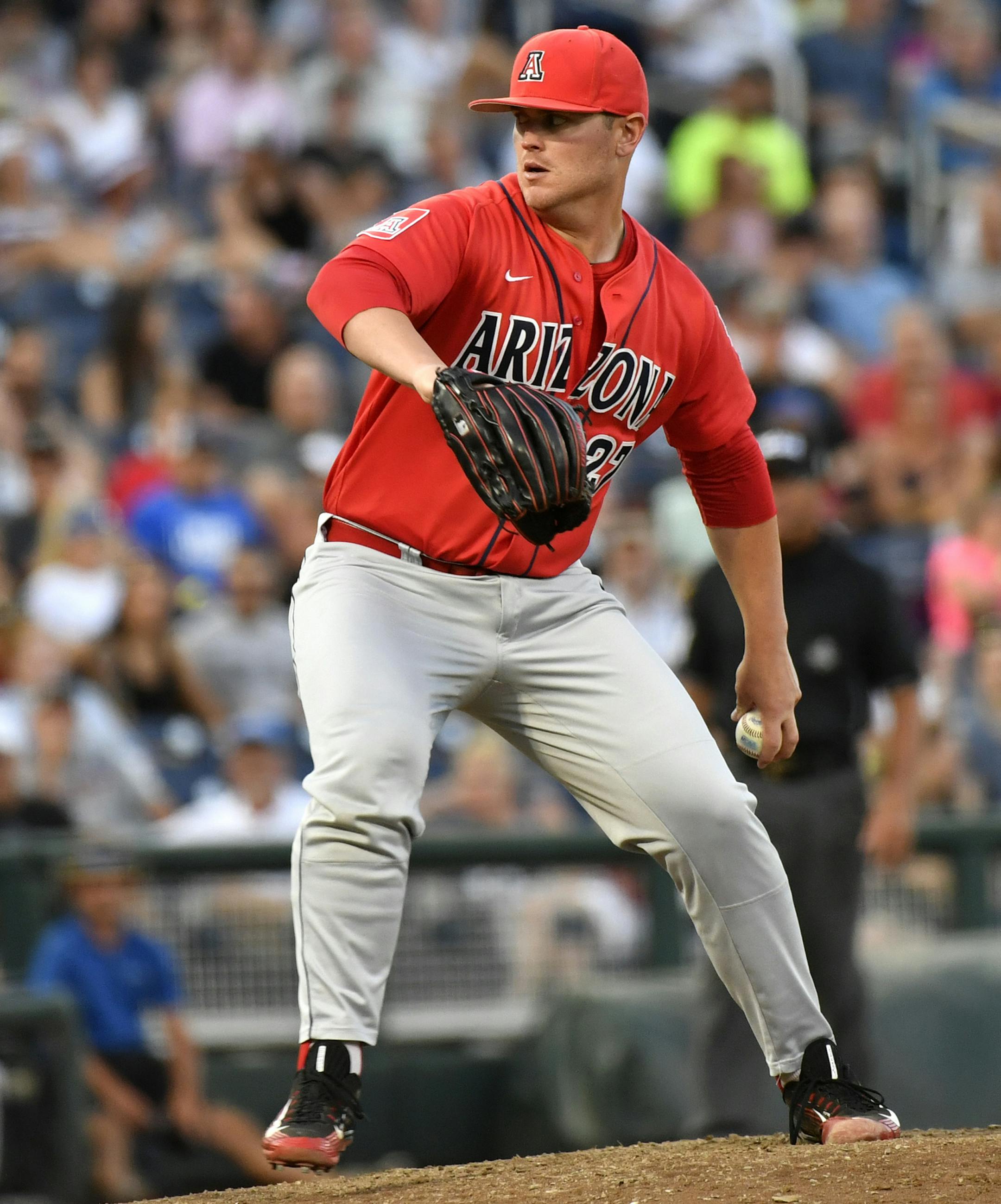Arizona pitcher JC Cloney (27) works against Coastal Carolina in the eighth inning in Game 1 of the NCAA Men's College World Series finals baseball game in Omaha, Neb., Monday, June 27, 2016. (AP Photo/Ted Kirk)