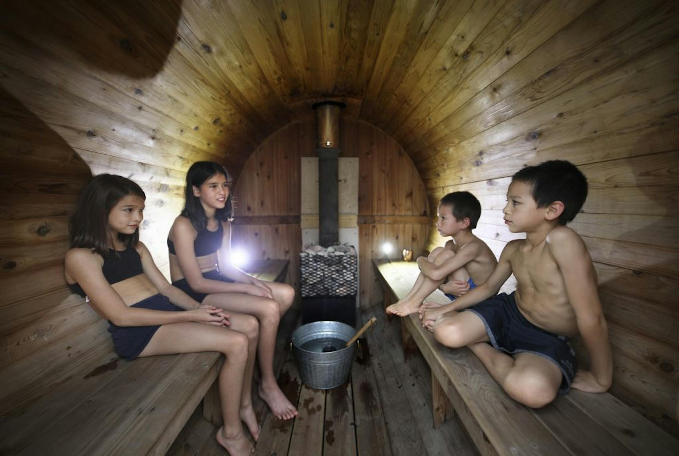 The Rice children, Nahla, 10, Becca, 12, Daniel, 6, and Hudson, 8, soak up the heat in the barrel sauna.