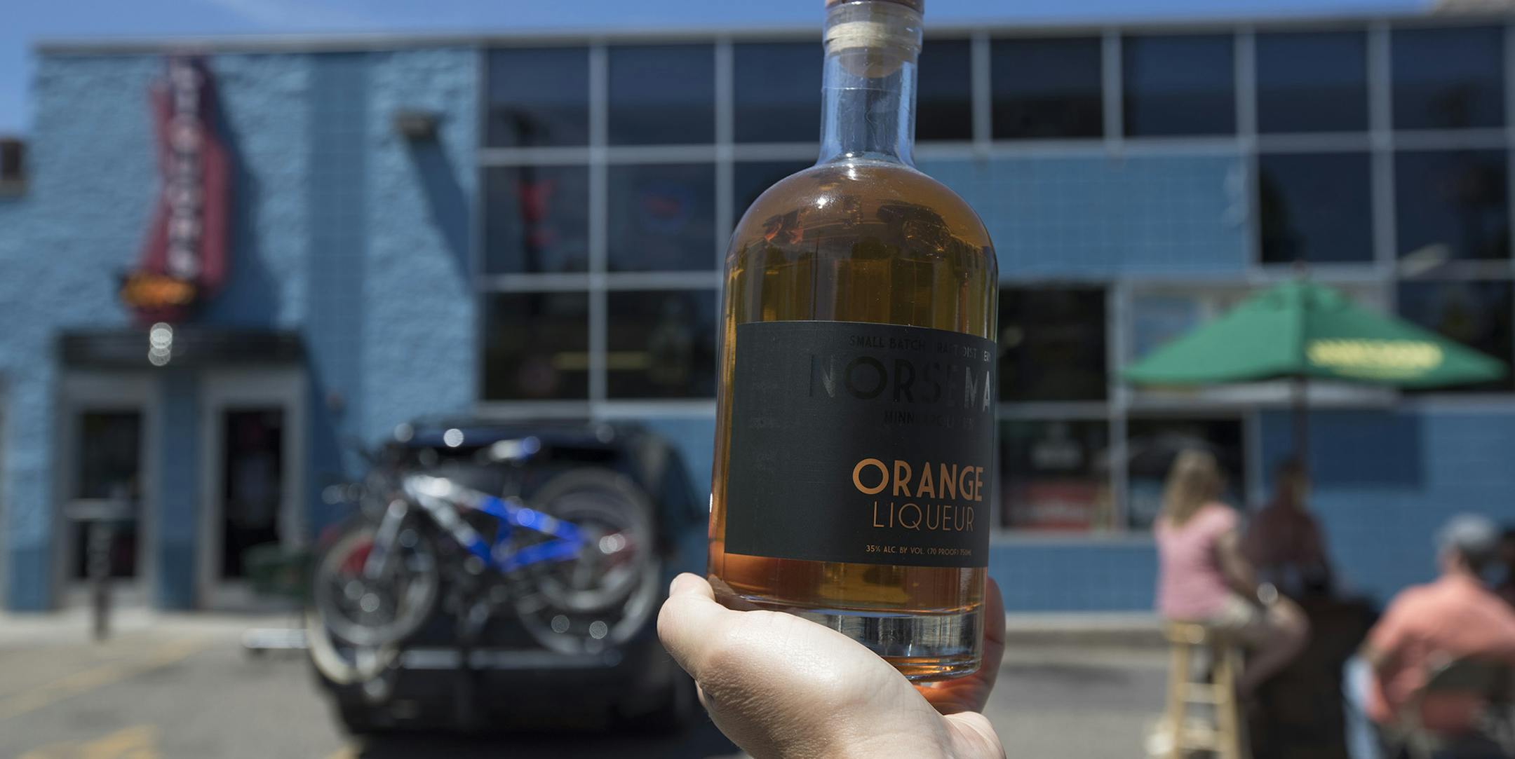 Sarah McGee of St. Paul, held a bottle of Norseman Orange Liqueur up to photograph that she bought at Zipps Liquors on the first day Sunday liquors sales in Minnesota July 2, 2017 in Minneapolis, MN. JERRY HOLT ï jerry.holt@startribune.com ORG XMIT: MIN1707021421321163