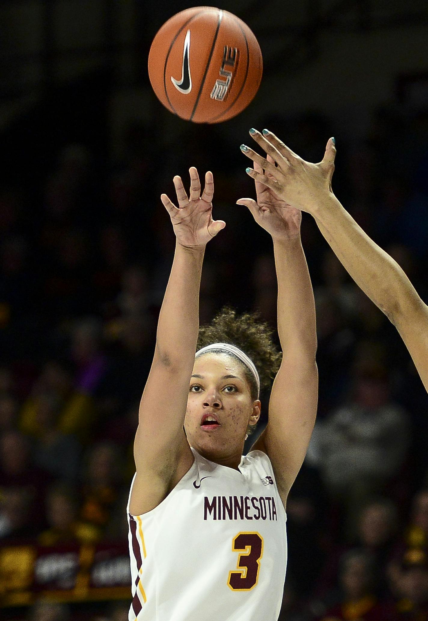 Minnesota guard/forward Destiny Pitts (3) hit a 3-pointer while being defended by Wisconsin forward Imani Lewis (34) during the second quarter of an NCAA college basketball game Friday, Dec. 28, 2018, in Minneapolis. (Aaron Lavinsky/Star Tribune via AP)