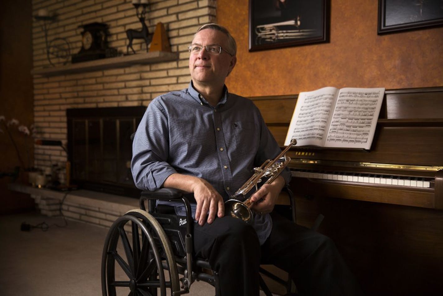 Bill Webb posed with his trumpet inside his home in Edina recently.