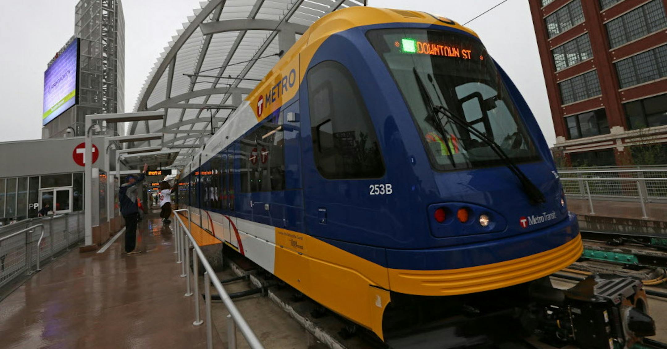 The first Green Line train left the Target Field Station slightly late from the scheduled 10 a.m. schedule on 6/14/14. Behind the group was the first Green Line train to leave the transit station.] Bruce Bisping/Star Tribune bbisping@startribune.com ORG XMIT: MIN1406141215210487