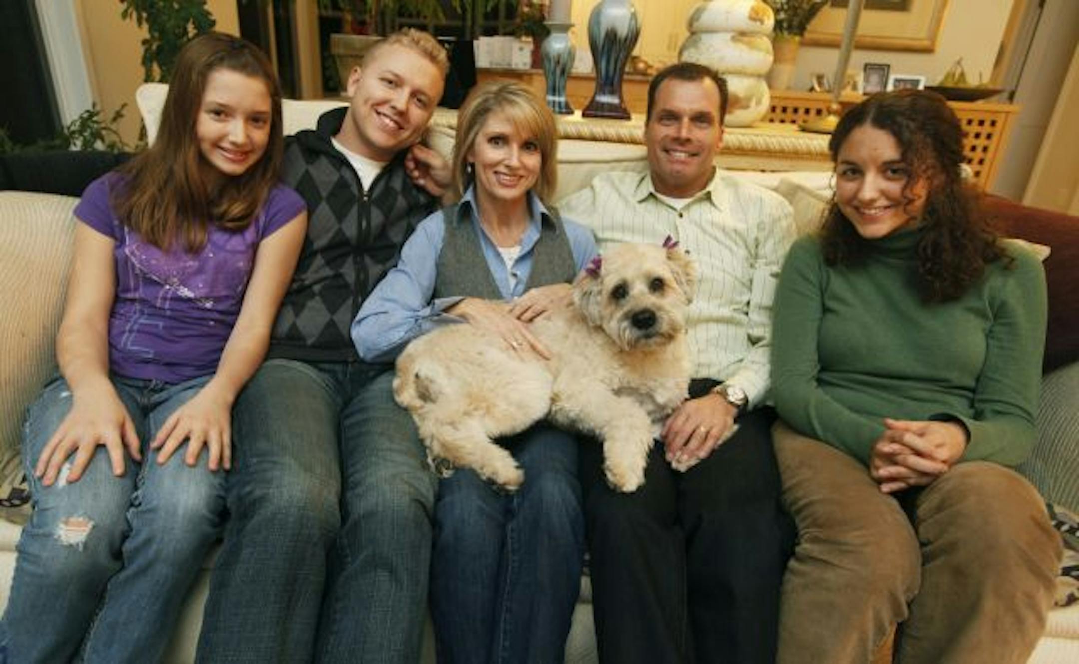 Left to right: Terri McCarthy, center, wrote "Parents-Get Your Head in the Game." Her children Sydnie, Dan, husband Jon and daughter Megan sit next to her on the couch.