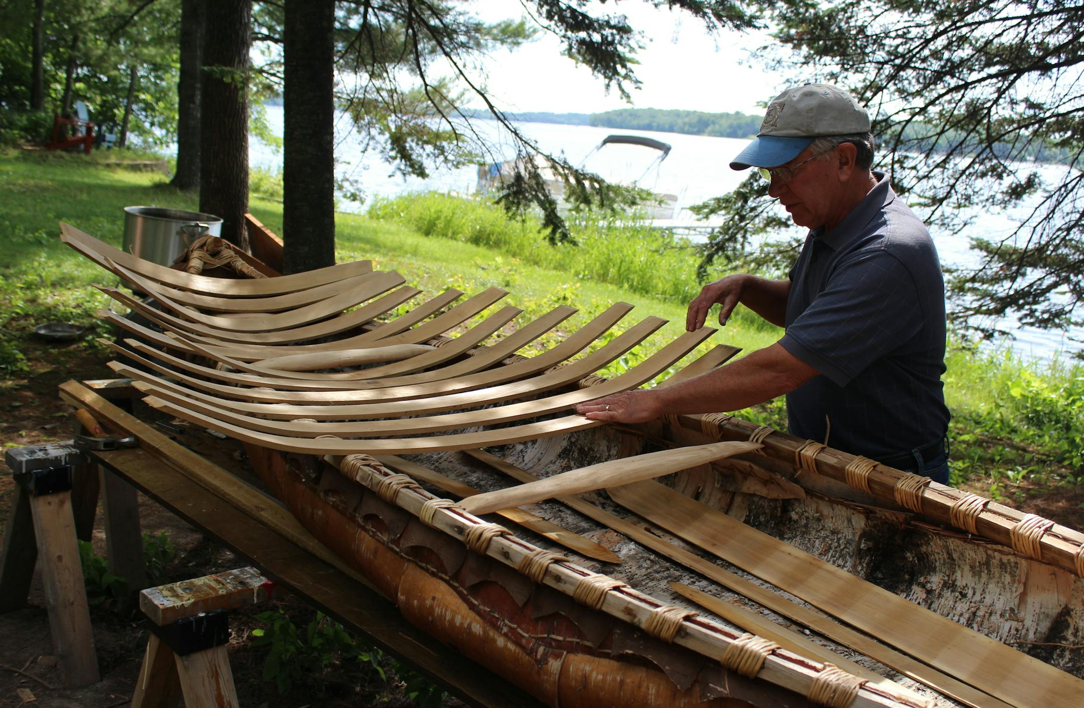 ADVANCE FOR MONDAY, AUG. 4 - David Gunelson, of Pengilly, Minn., who has built and restored about 10 wooden boats, works on a birch bark canoe July 24, 2014, in Pengilly. (AP Photo/The Daily Tribune, Tony Potter)