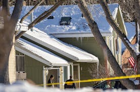Police investigate the scene where two police officers and a fire department medic were shot and killed in Burnsville, Minn., on Sunday, Feb. 18, 2024