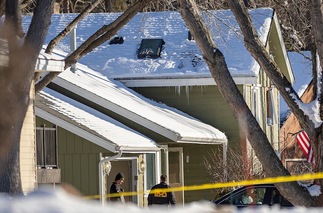 Police investigate the scene where two police officers and a fire department paramedic were shot and killed in Burnsville on Sunday.