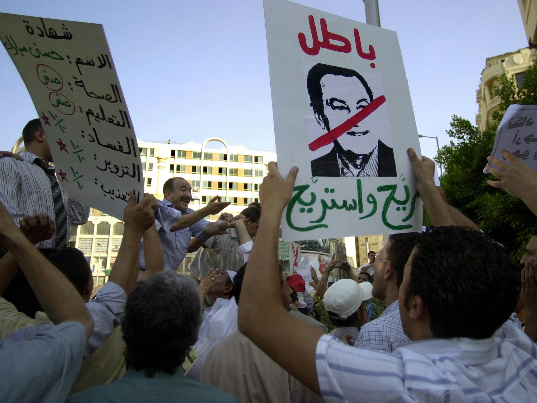 More than 100 members and supporters of the Kifaya movement and other opposition groups gathered at Opera Square chanting anti-President Hosni Mubarak slogans and protested unemployment and corruption Wednesday Aug.3, 2005. The banner reads 'No to Corruption, No to Dictatorship'. The 77-year-old Mubarak, in power since 1981, announced his candidacy last week and is widely expected to win a fifth term. (AP Photo/Mohamed al Sehety) ORG XMIT: CAI103