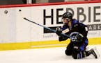The Minnesota Whitecaps Amanda Boulier (8) shoots from her knees during the second period of the Whitecaps 5-1 win over the Metropolitan Riveters in t