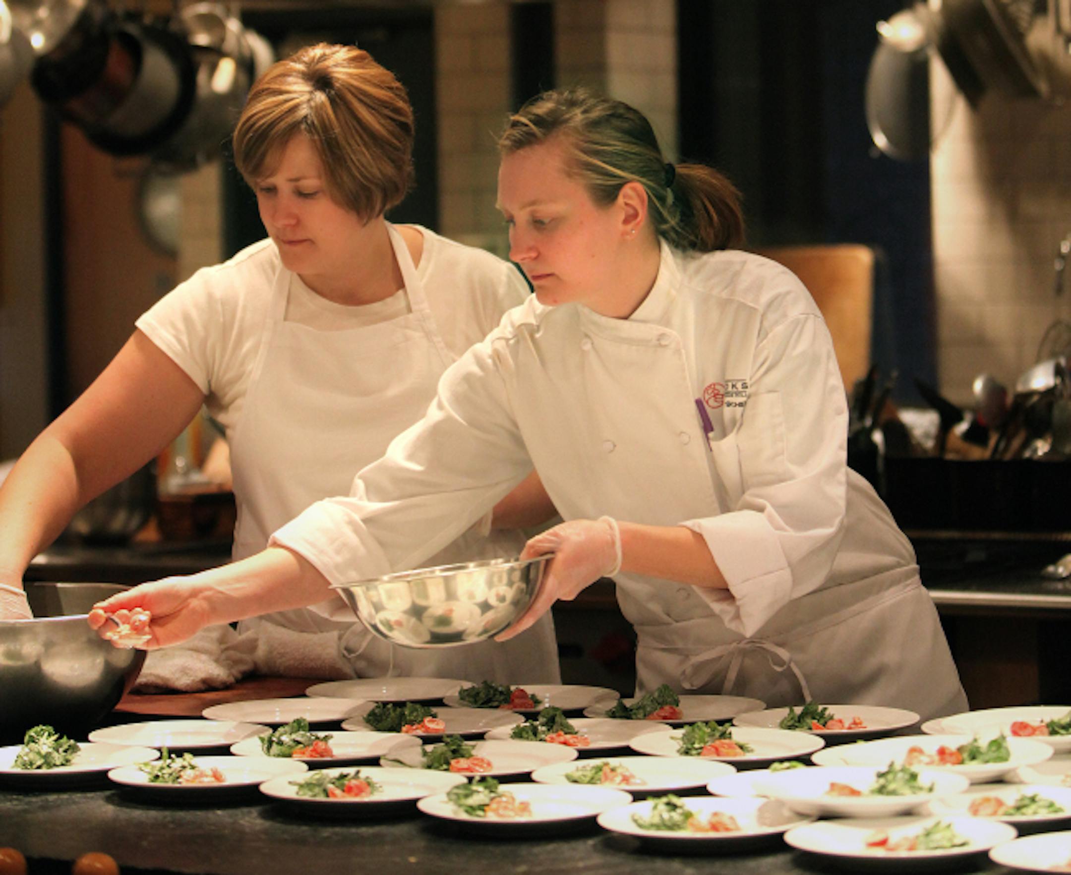 Assistant Lilian Scull and chef Mary Scheu assemble mini-mushroom tarts at Cooks of Crocus Hill.