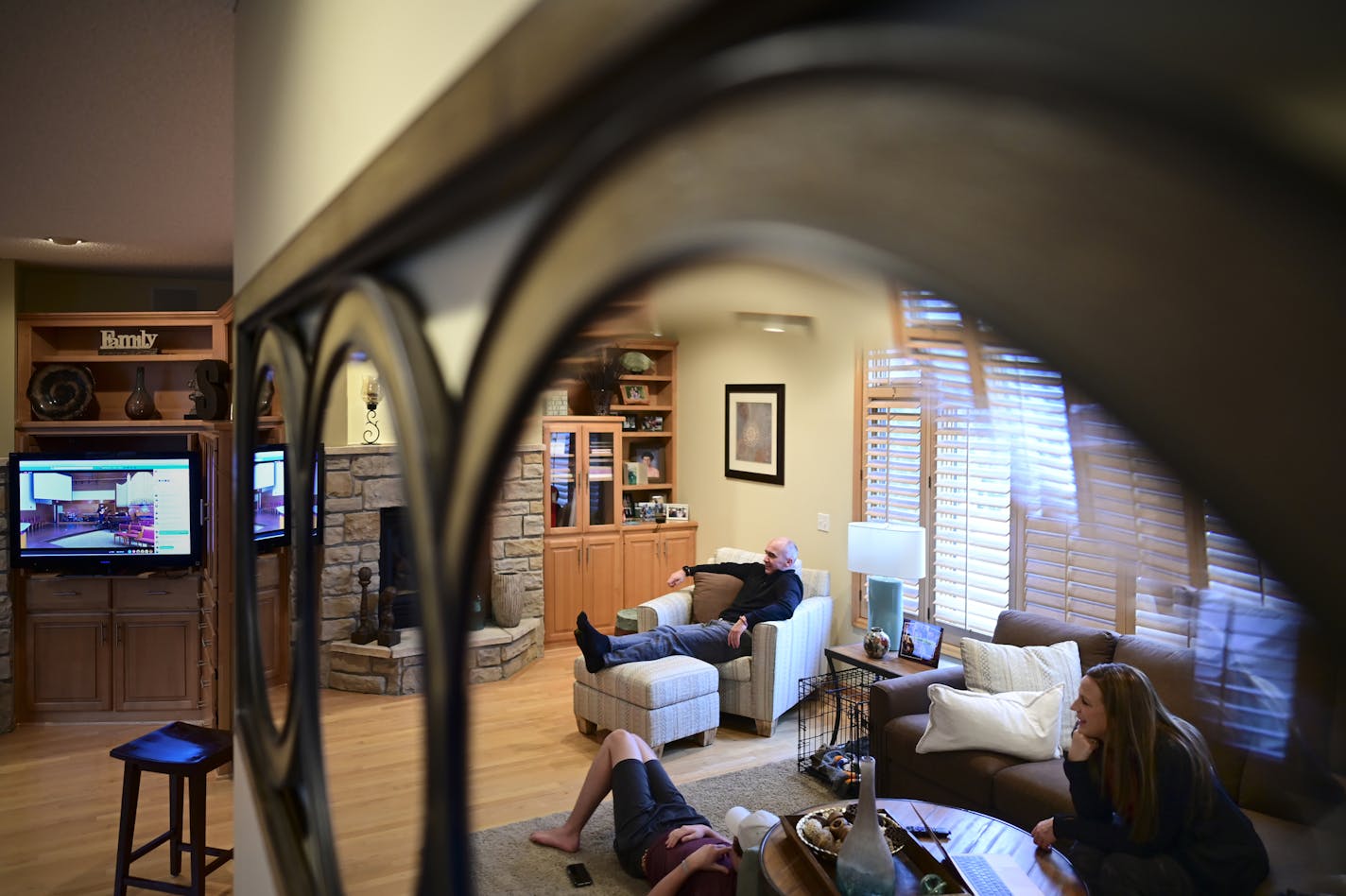 Ric and Michelle Saatzer watched the musical opening of their Wednesday night church service with their kids Tony, 16, and Abi, 13, at their home.