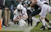 Penn State quarterback Sean Clifford, left, dives for a first down against Michigan State.