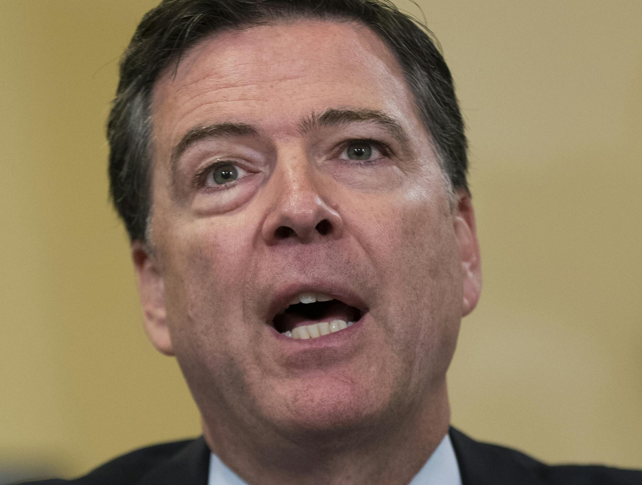 FILE - In this July 14, 2016 file photo, FBI Director James Comey testifies on Capitol Hill in Washington. The FBI informed Congress Friday, Oct. 28, 2016, it is investigating whether there is classified information in new emails that have emerged in its probe of Hillary Clinton's private server. The FBI said in July its investigation was finished. (AP Photo/Evan Vucci, File)