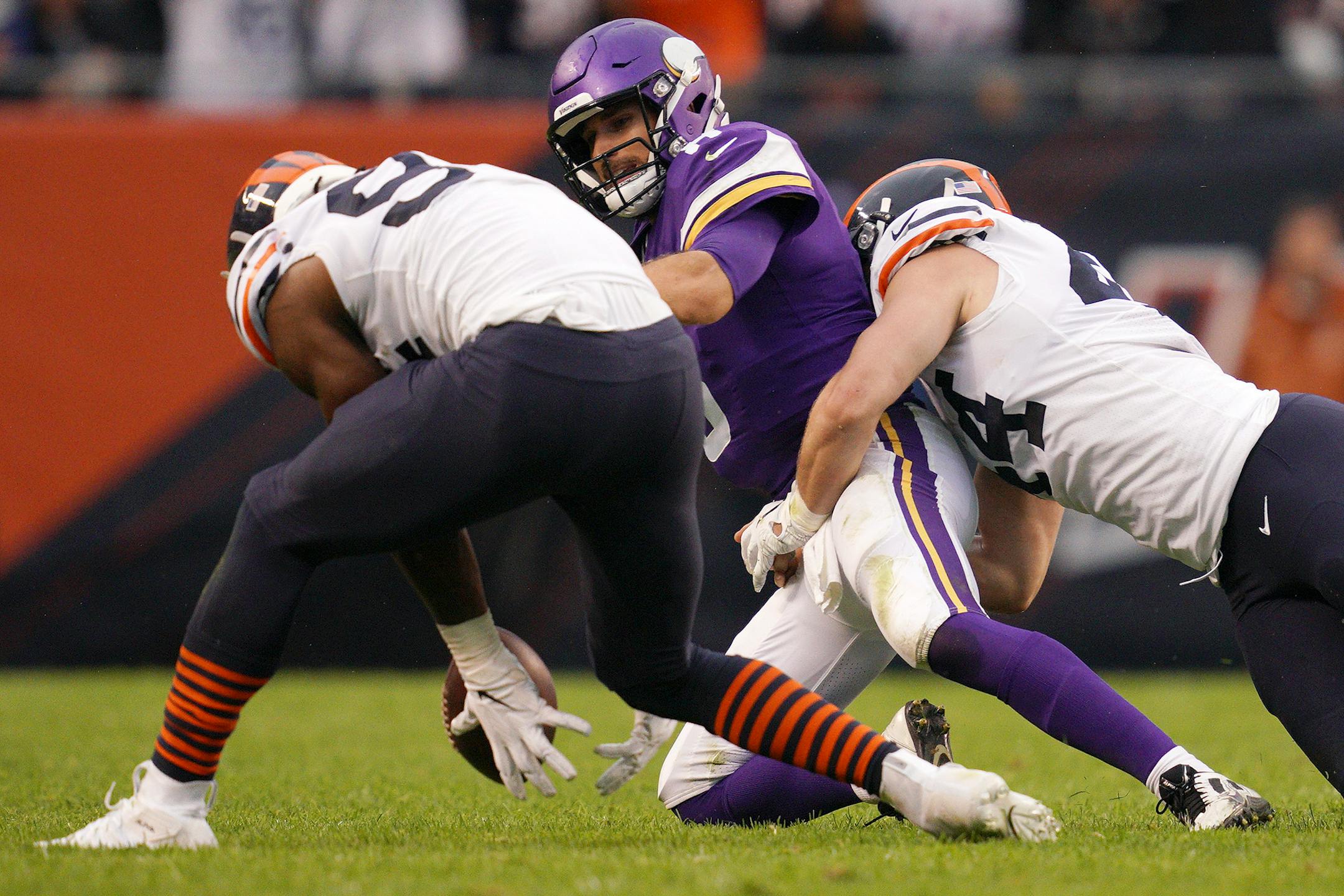 Chicago Bears outside linebacker Leonard Floyd (94) reached down to scoop up the ball after Minnesota Vikings quarterback Kirk Cousins (8) fumbled it as he was sacked by Chicago Bears inside linebacker Nick Kwiatkoski (44) in the third quarter.
