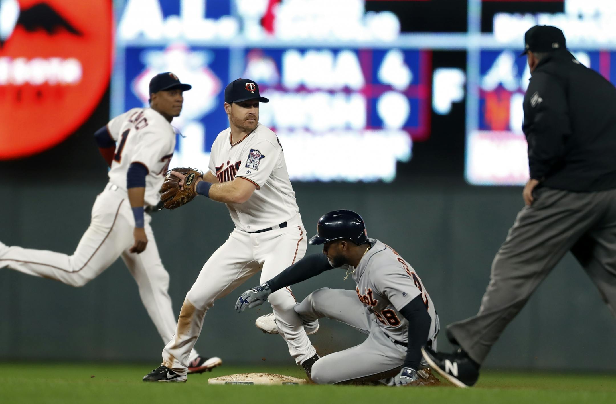 Niko Goodrum(28) stops Logan Forsythe(24) from turning the double play .
