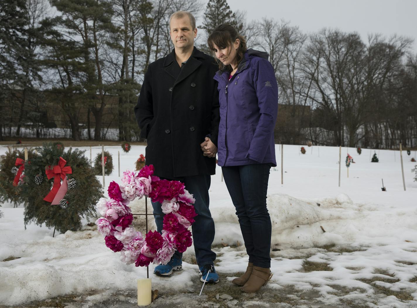 Jon Markle and his wife Mandy Markle stood at their daughter Tabitha's grave in Mendota Heights, Minn., on Sunday, February 18, 2018. Five years ago Jon Markle drove onto frozen Lake Minnetonka with his family when the thin ice in a channel gave way. He, along with his wife and 2 1/2 year old daughter escaped. But efforts to free his 9-month-old baby from her car seat failed. He lives today with the regret and weight of his decisions that night. But vowed to keep his family together.] RENEE JONE