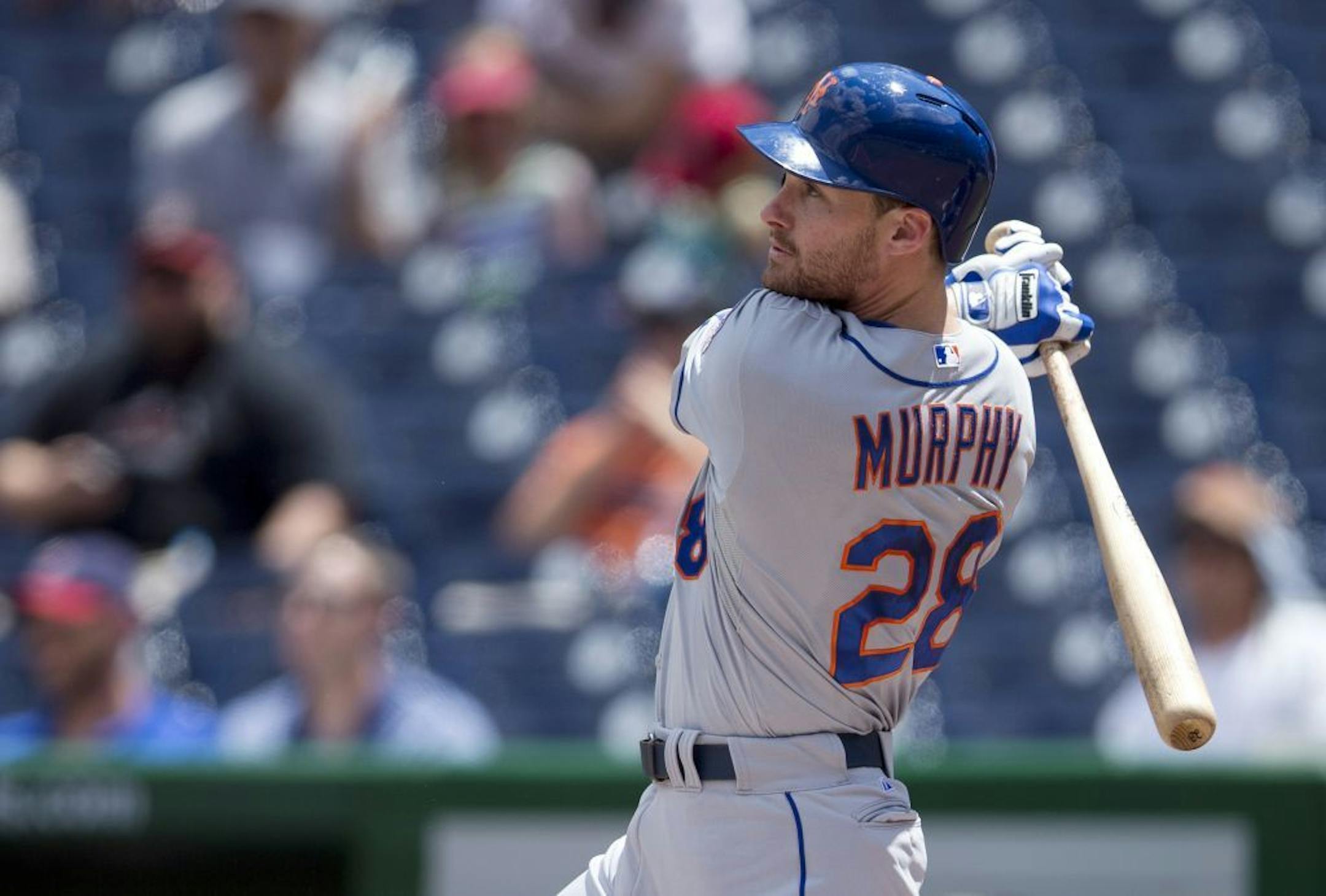 New York Mets Daniel Murphy hits a solo home run during the first inning of a baseball game against the Washington Nationals at Nationals Park on Friday, July 26, 2013, in Washington. The Mets defeated the Nationals 11-0 in the first game of a doubleheader.