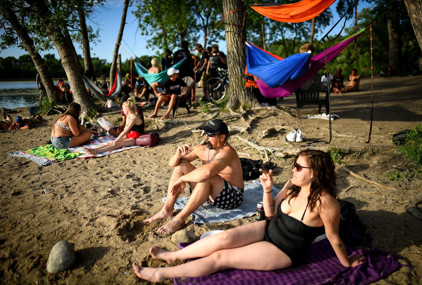 Friends Rosie Mudrey and Bruce Hawks smoked cigars while hanging out after work at Hidden Beach. "It's always had a reputation of being a laid back, chill place," said Mudrey. Four years ago, after summer of problems at the beach, neighbors had considered closing it down.