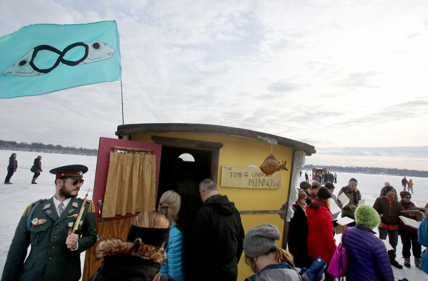 The&#x2020;2018 Art Shanty Projects transformed frozen Lake Harriet into a giant playground for adults and children Saturday, Jan. 20, 2018, in Minneapolis, MN. Here, a guard armed with an ice fishing pole stands guard outside the Tomb of the Unknown Minnow, by artists Nicholas Maurstad, Angela Maki North and Mike Taus, and is a mausoleum honoring the sacrifices made by minnows throughout the year as bait for Minnesotans fishing for food or sport. ] DAVID JOLES &#xef; david.joles@startribune.com