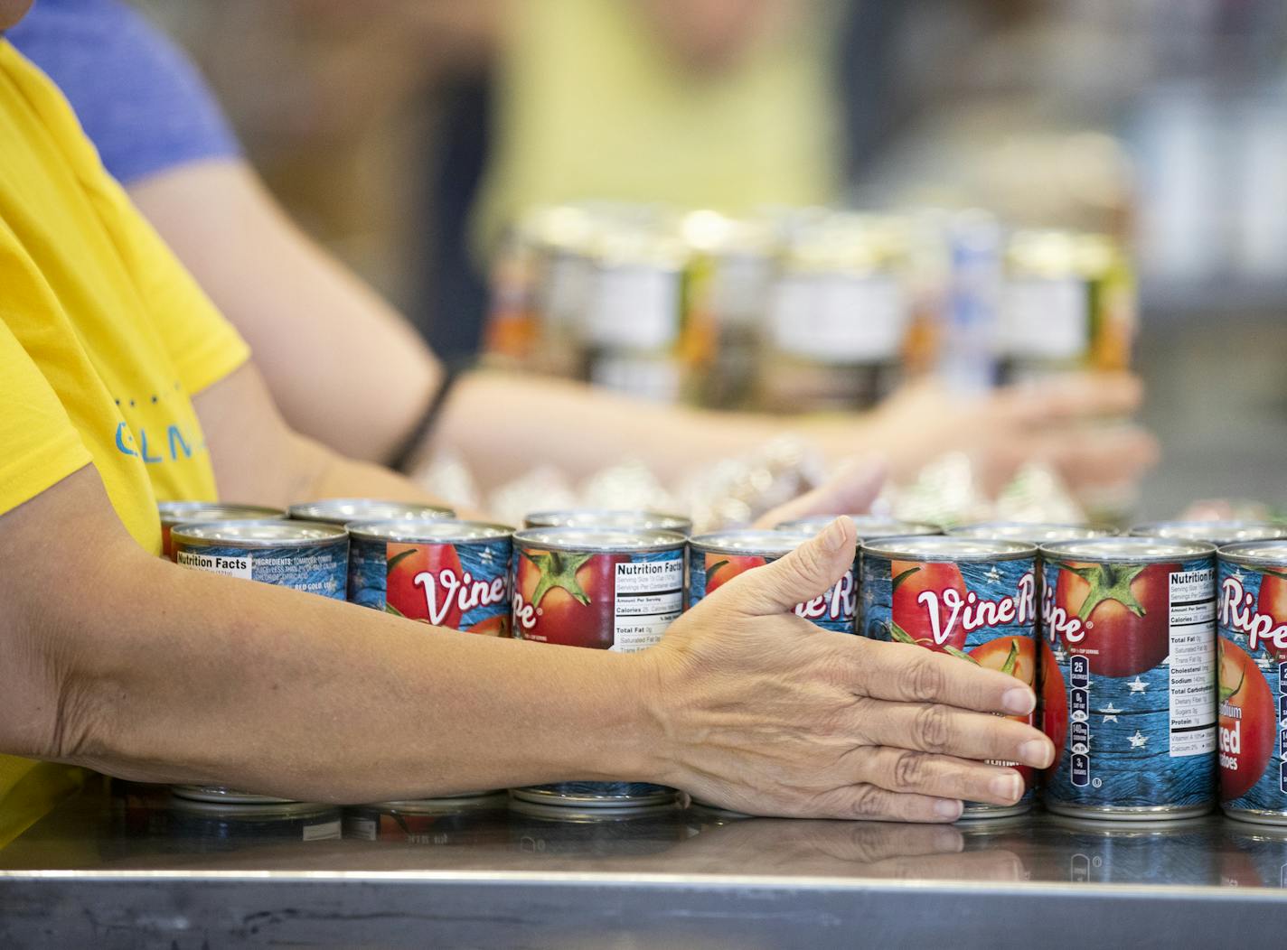 A volunteer organizes food to pack for the FOODRx program. FOODRx aims to connect food prescriptions and basic need services to low income patients through the MN health care system. ] LEILA NAVIDI &#xef; leila.navidi@startribune.com BACKGROUND INFORMATION: Volunteers pack food at the new warehouse location for Second Harvest Heartland on Friday, September 7, 2018. Second Harvest Heartland received $18 million in bonding to open a larger warehouse in Brooklyn Park with more refrigeration for fre