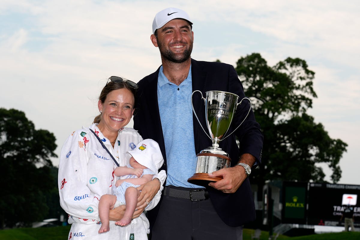 Scottie Scheffler poses with his baby son, Bennett, and his wife, Meredith, after winning the Travelers Championship on Sunday in Cromwell, Conn.