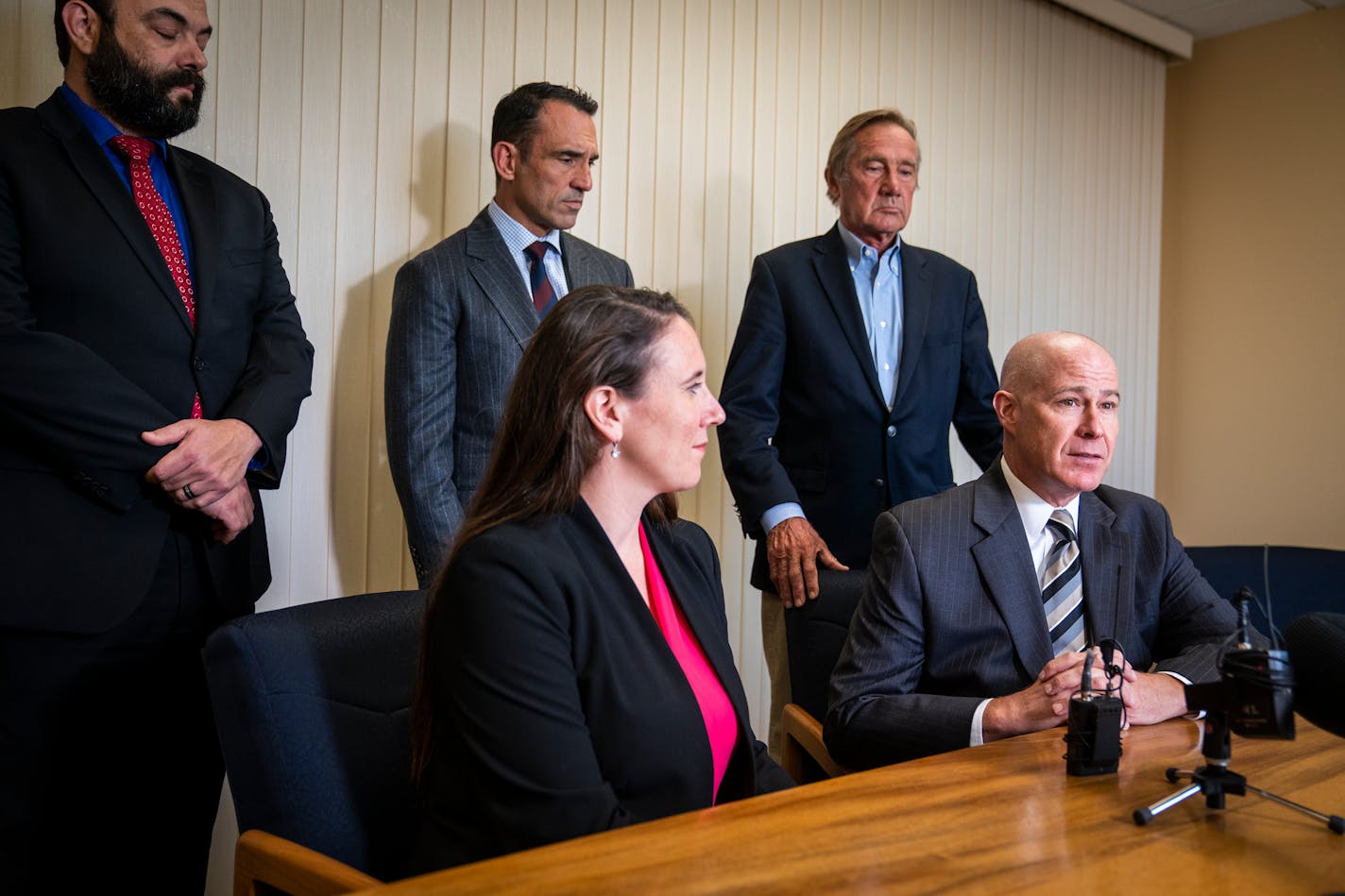 Thomas Plunkett, bottom right, the attorney for former Minneapolis police officer Mohamed Noor, speaks during a news conference at his office with his team of lawyers about the Minnesota Supreme Court's decision to overturn Noor's third-degree murder conviction, Wednesday, Sept. 15, 2021, in St Paul, Minn. With Plunkett clockwise from bottom left are attorneys Caitlinrose Fisher, Dan Koewler, Matt Forsgren and Peter Wold. Noor was convicted of third-degree murder and second-degree manslaughter in the 2017 death of Justine Ruszczyk Damond, a dual U.S.-Australian citizen who called 911 to report a possible sexual assault behind her home. (Leila Navidi/Star Tribune via AP)