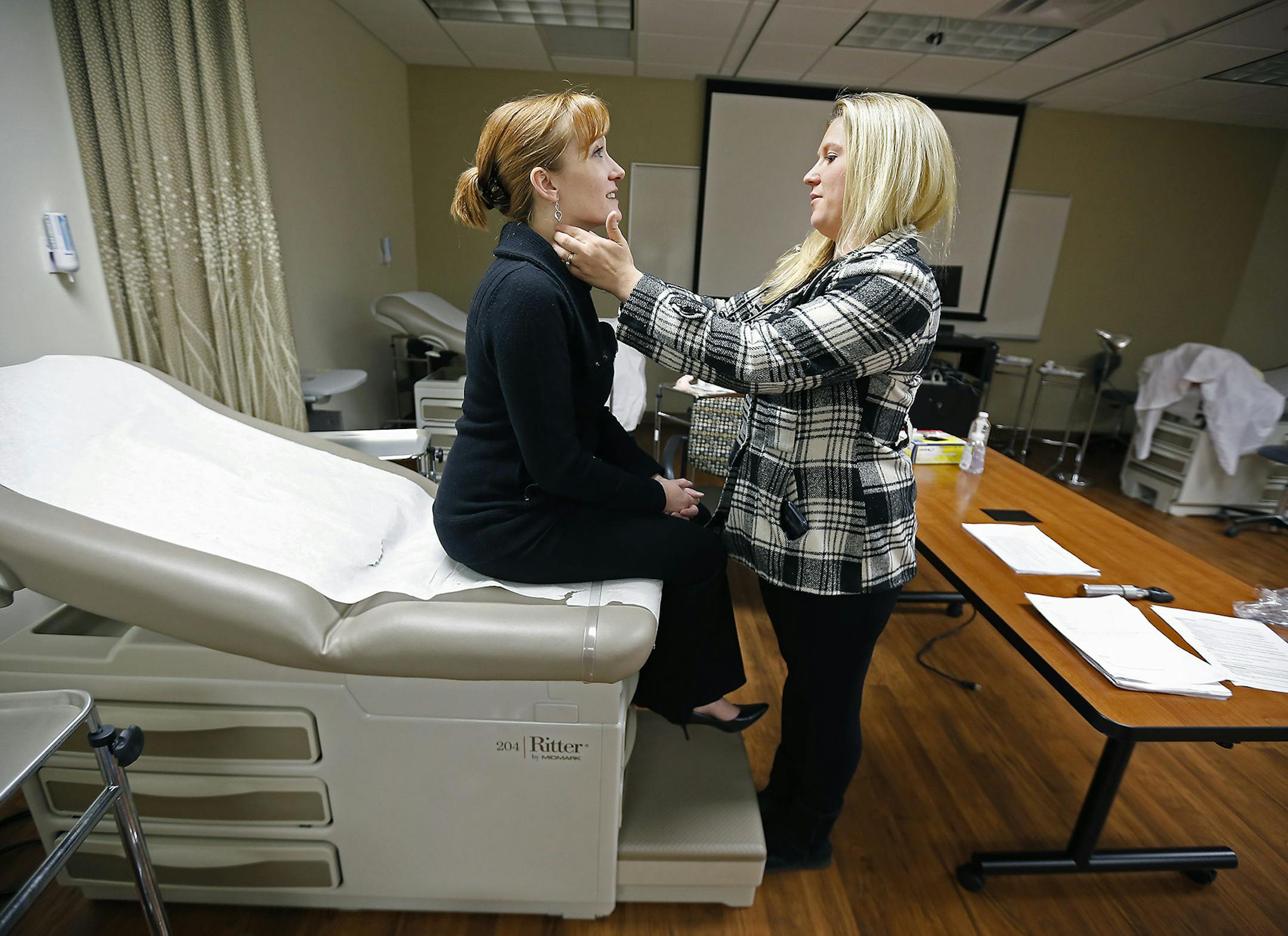 Bethel College nurse-midwife students, Nicole Hunter-Severson, left, and Brittany Schultz, practiced their exams at Bethel College, Friday, November 14, 2014 in Arden Hills, MN. The college has started one of the first nurse-midwife programs taught almost completely online from "a distinctly Christian perspective." ] (ELIZABETH FLORES/STAR TRIBUNE) ELIZABETH FLORES • eflores@startribune.com