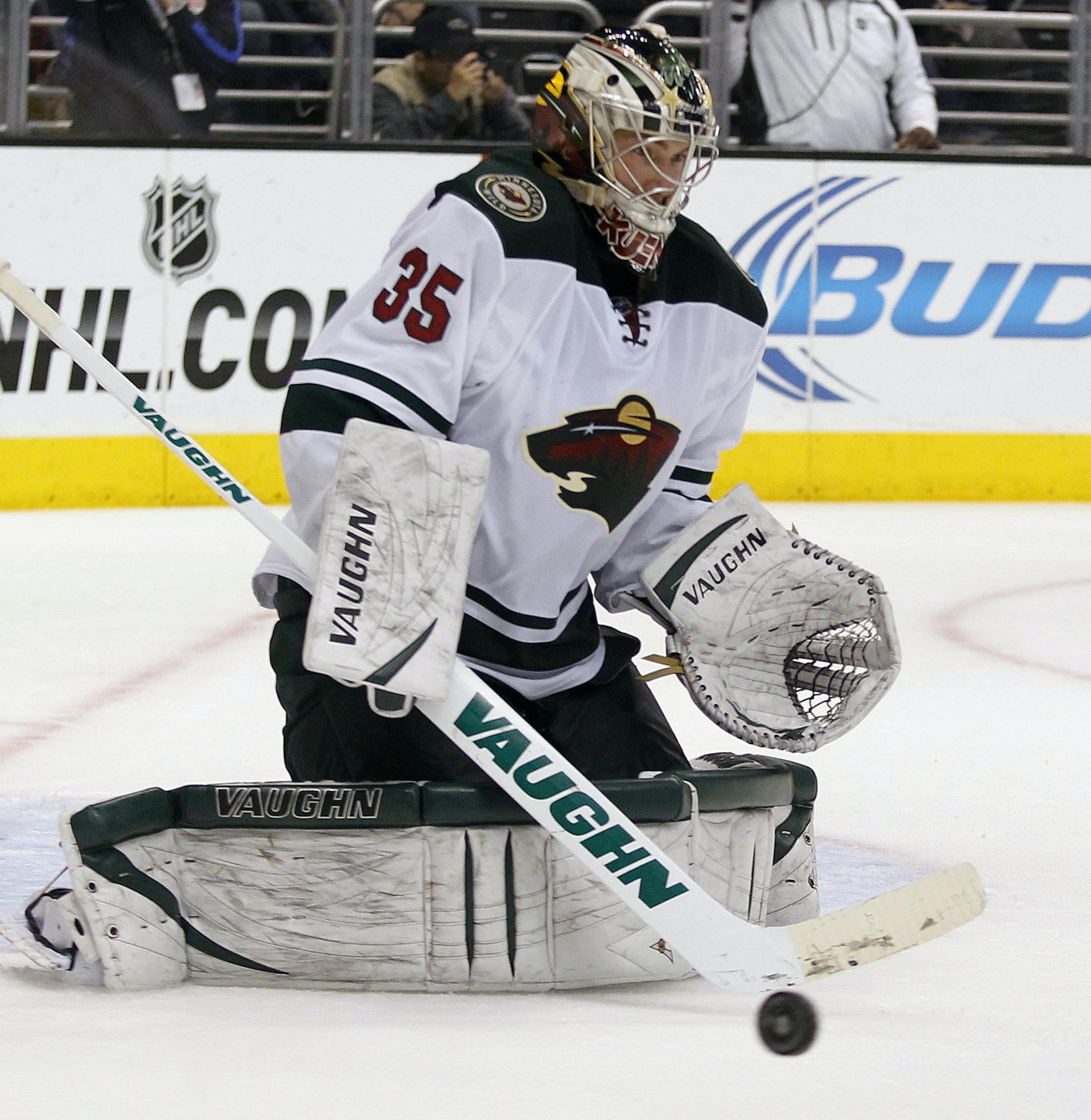 Minnesota Wild goalie Darcy Kuemper makes a stick save against the Los Angeles Kings during the second period of an NHL hockey game Tuesday, Jan. 7, 2014, in Los Angeles. (AP Photo/Alex Gallardo)