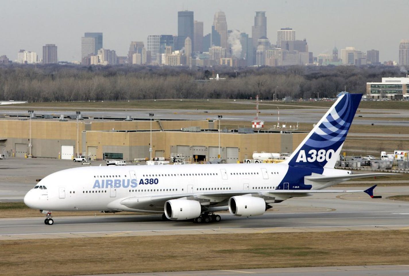 In this Nov. 27, 2007 file photo, the Minneapolis skyline rises in the distance as an Airbus A380 taxies at Minneapolis-St. Paul International Airport in Minneapolis. Minnesota Gov. Tim Pawlenty has hinted that his January budget proposal will include proposals to privatize some of what the state owns or does. GOP lawmakers are pushing to privatize the Minneapolis-St. Paul International Airport and the state lottery.