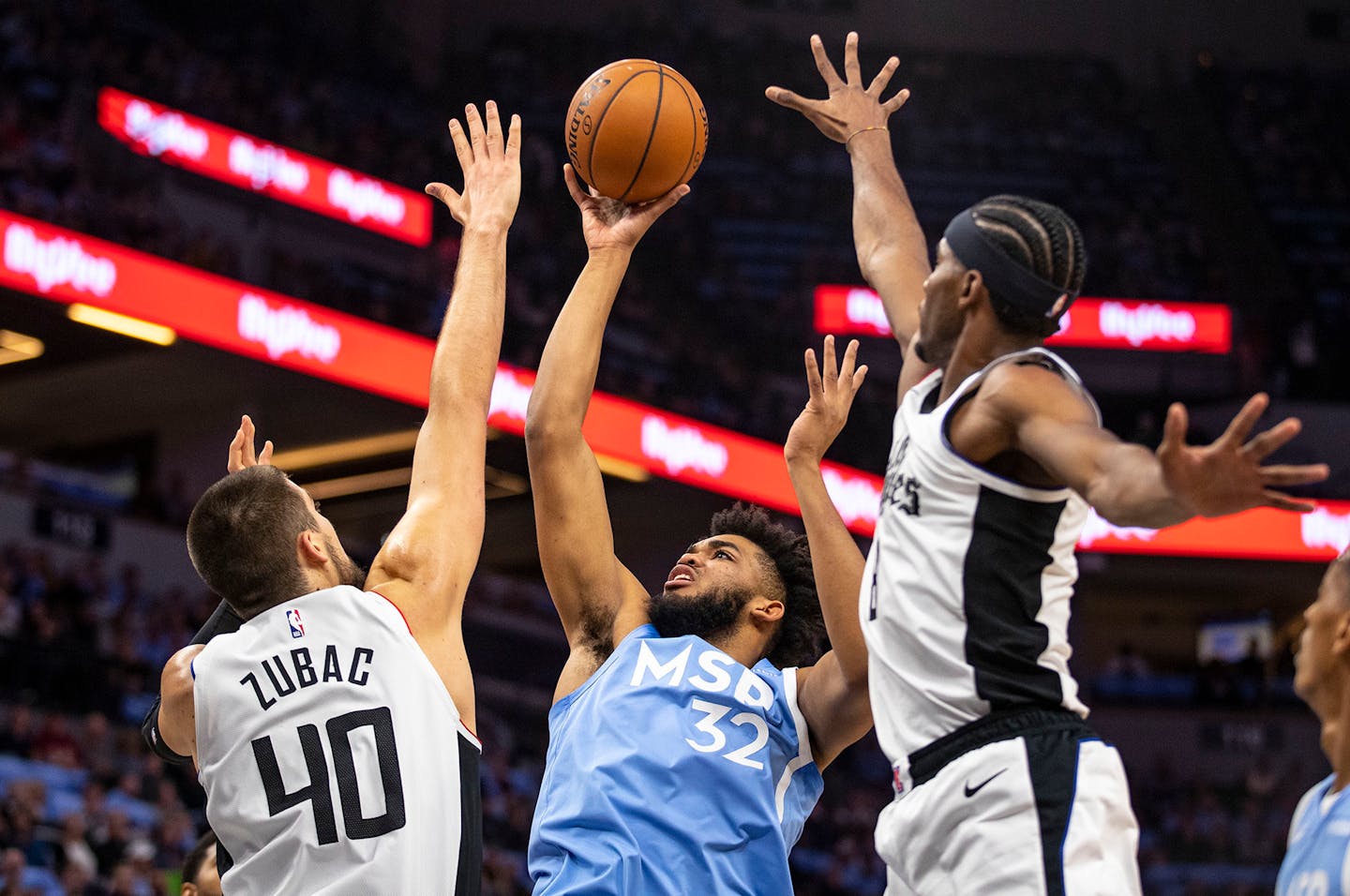 Timberwolves center Karl-Anthony Towns puts up a shot against pressure from the Los Angeles Clippers' Ivica Zubac