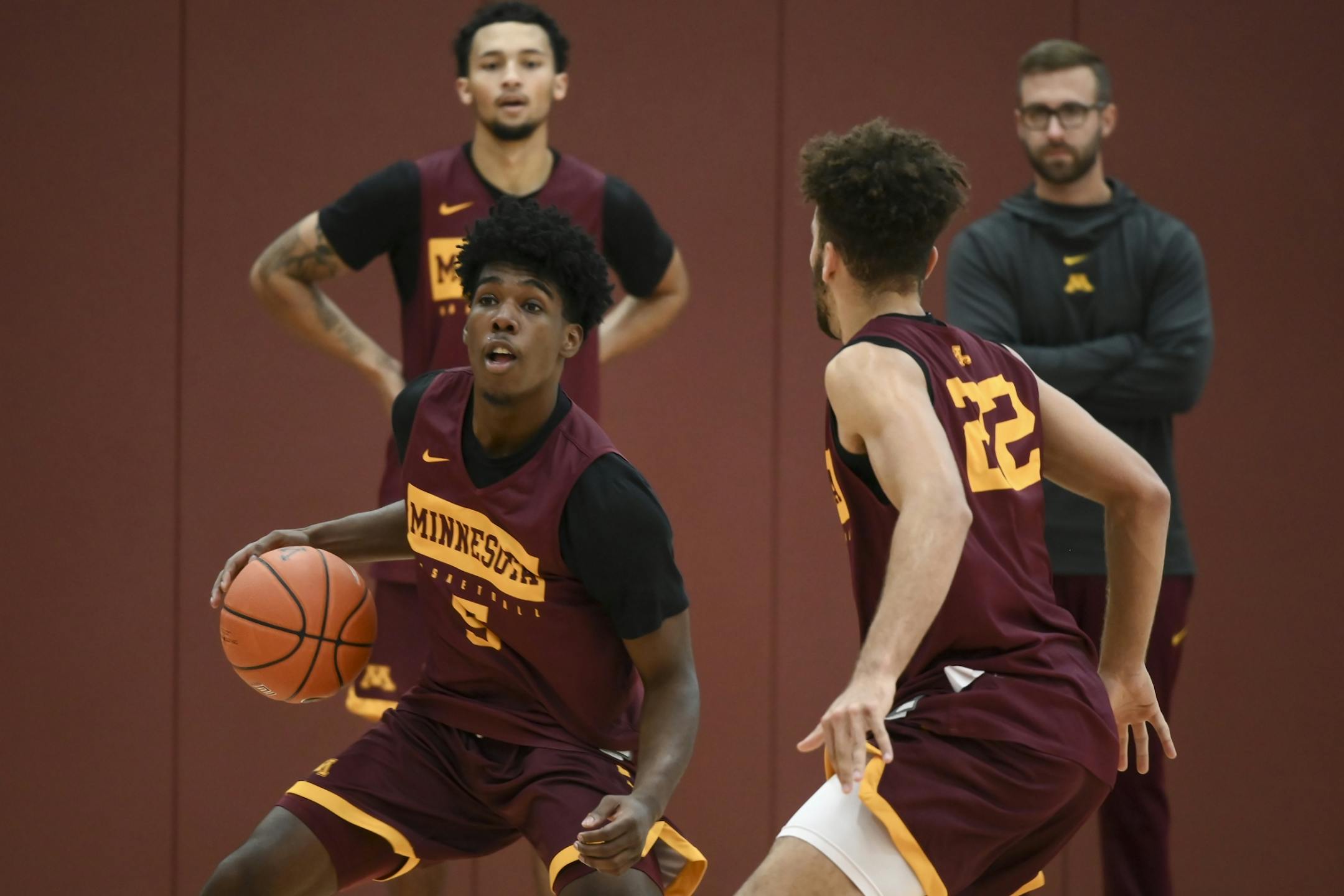 Gophers guard Marcus Curr handled the ball during Tuesday's practice as he was defended by guard Gabe Kalscheur (22).