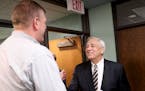 On his way out after being introduced as the interim St. Paul Public Schools superintendent John Thein, right, greets a well wisher Wednesday, June 22