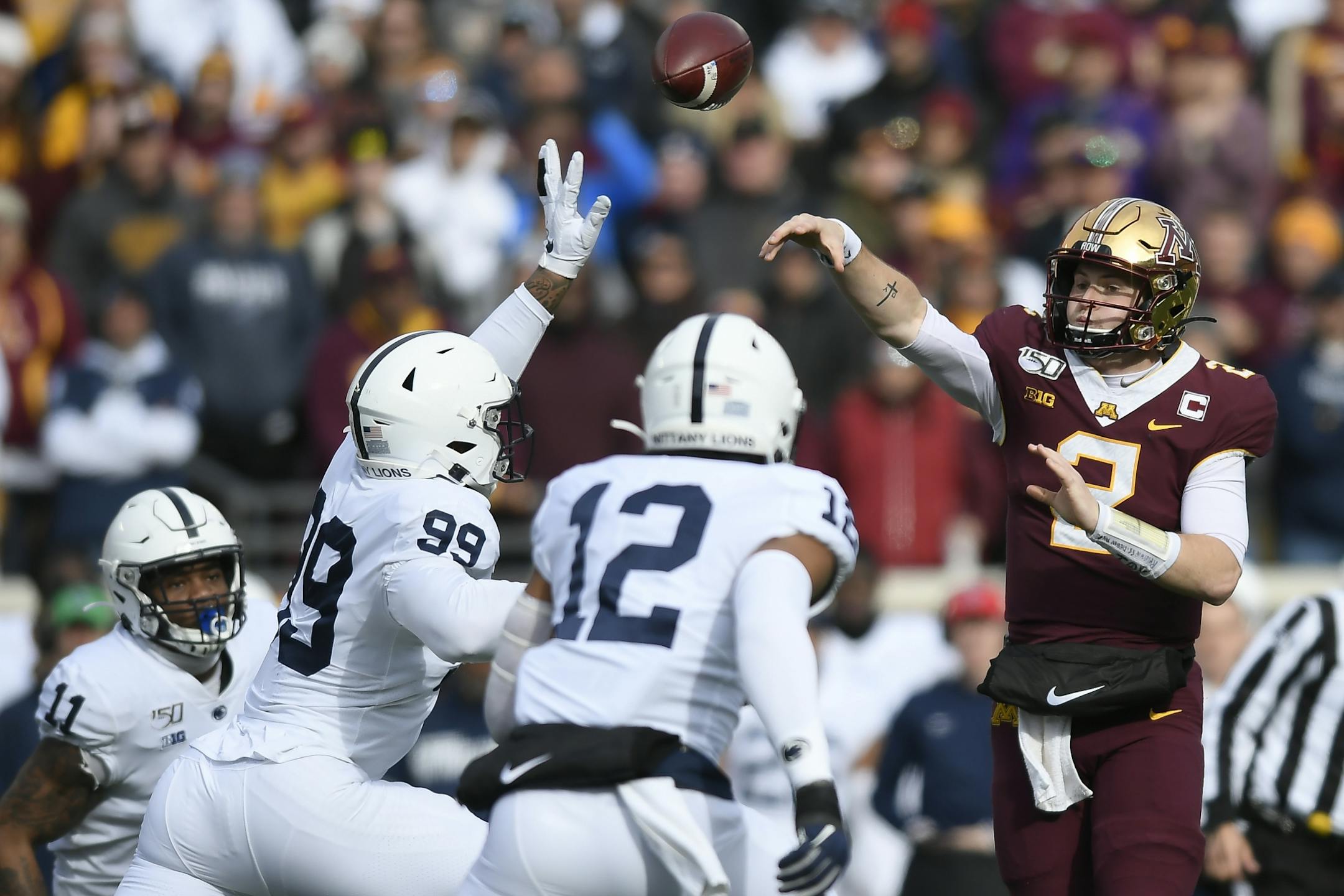 Minnesota Gophers quarterback Tanner Morgan (2) threw the ball under pressure by Penn State Nittany Lions defensive end Yetur Gross-Matos (99) in the second quarter.