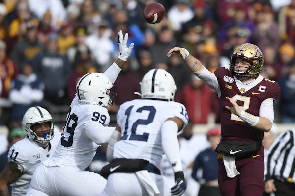 Minnesota Gophers quarterback Tanner Morgan (2) threw the ball under pressure by Penn State Nittany Lions defensive end Yetur Gross-Matos (99) in the 